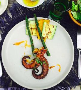 a plate of food with a snake on it at All inclusive beachfront villa in Sian kaan in Tulum