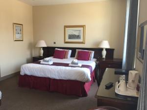 A bed or beds in a room at Marine Hotel 