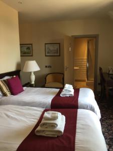 A bed or beds in a room at Marine Hotel 