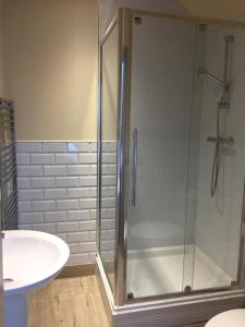 a bathroom with a shower and a sink at Marine Bar Pub with Rooms in Hunstanton