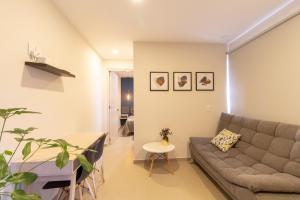 a living room with a couch and a table at Lofts Santa Fe in Guadalajara