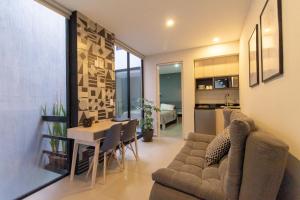 a living room with a couch and a table at Lofts Santa Fe in Guadalajara