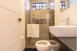 a bathroom with a toilet and a sink at Lofts Santa Fe in Guadalajara +39 photos
