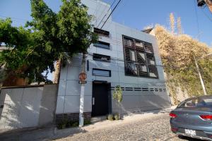 a white building with a stop sign in front of it at Lofts Santa Fe in Guadalajara
