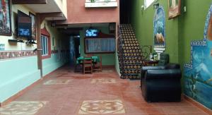 einen Restaurantflur mit grünen Wänden sowie einem Tisch und Stühlen in der Unterkunft El Portón de Cortés in Tepeaca