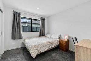 a bedroom with a bed and a window at Erskine Place - Lake Hawea Holiday Home in Lake Hawea