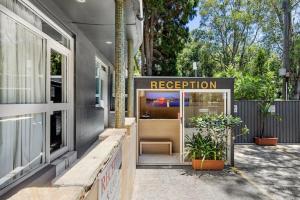a building with a reception sign in front of it at Greenwich Inn Motel in Sydney