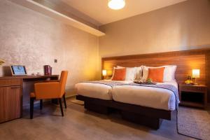 a bedroom with a bed and a desk and a chair at Dellarosa Boutique Hotel and Spa in Marrakech