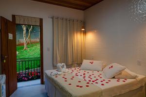 a bedroom with a bed with red hearts on it at Pousada Vila Catarina in Ouro Preto