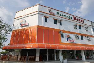 a building with a sign on the side of it at MORNINGS HOTEL in Sungai Petani