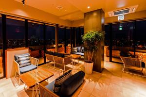 a living room with a view of a city skyline at PROSTYLE TERRACE NAHA in Naha