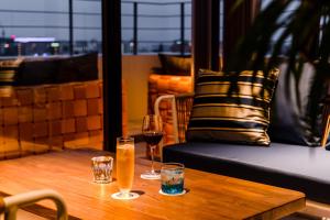 a wooden table with two glasses of wine at PROSTYLE TERRACE NAHA in Naha +109 photos