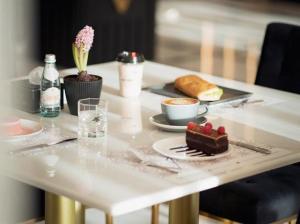 a white table with a plate of food on it at فندق الودق ALwadaq Hotel in Taif