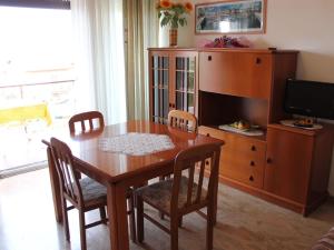 a wooden dining room table with chairs and a tv at Holiday Home in Lazise near Lake Garda in Lazise