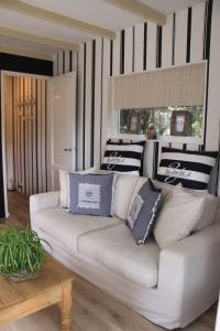 a white couch in a living room with black and white stripes at Summerhouse Zandvoort in Zandvoort