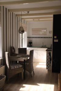 a kitchen and dining room with a table and chairs at Summerhouse Zandvoort in Zandvoort