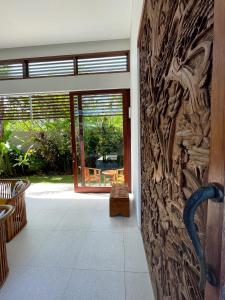 a room with a wall with a carving of animals at Villa Capella in Canggu
