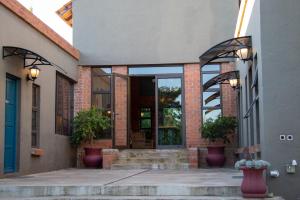 an entry to a building with a blue door at Bel Tramonto in Bloemfontein