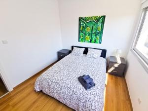1 dormitorio con 1 cama con edredón en Daze Off Central Apartment, 300m to the Finikoudes Beach, en Lárnaca