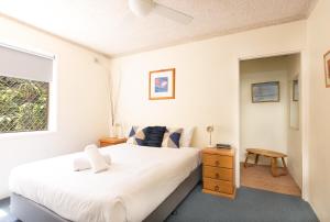 a bedroom with a large white bed and a window at Yamba Towers 2 - LJHooker Yamba in Yamba