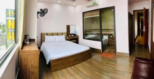 Ένα ή περισσότερα κρεβάτια σε δωμάτιο στο MV Hotel