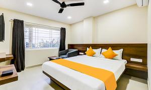 a bedroom with a large bed and a window at FabHotel Rove Inn & Suites Jalahalli West in Chik Bānavar