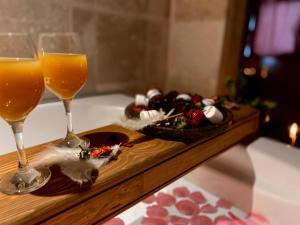 a tray with two glasses of wine and a plate of food at Alice in Cappadocia in Uçhisar +79 photos