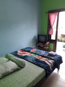 Tempat tidur dalam kamar di Kampoeng Tourist Homestay