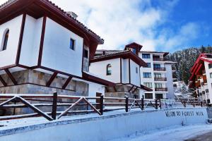 a building with a fence in front of it at Forest Nook Villas in Pamporovo