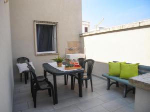 a patio with a table and chairs on a balcony at Appartamenti Le vie di Omero in Torre dell'Orso +50 photos