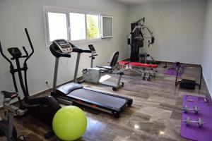 a gym with several exercise equipment in a room at Lido Corfu Sun Hotel 4 Stars All-inclusive in Benitses