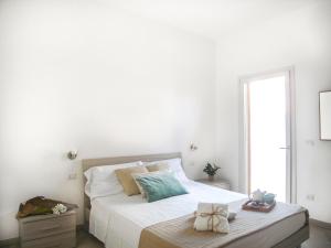 A bed or beds in a room at Appartamenti Via Corfù - Le vie di Omero