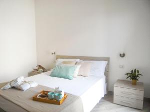 A bed or beds in a room at Appartamenti Via Corfù - Le vie di Omero