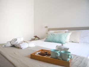A bed or beds in a room at Appartamenti Via Corfù - Le vie di Omero