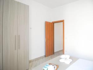 A bed or beds in a room at Appartamenti Via Corfù - Le vie di Omero