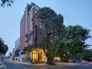 a building with a tree in front of it at Le Foliage by TGI in Bangalore