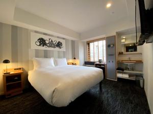 Postel nebo postele na pokoji v ubytování UMEDAHOLIC HOTEL