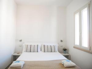 A bed or beds in a room at Appartamenti Via Corfù - Le vie di Omero