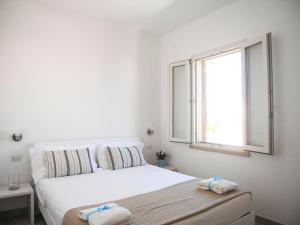 A bed or beds in a room at Appartamenti Via Corfù - Le vie di Omero