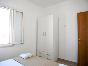 A bed or beds in a room at Appartamenti Via Corfù - Le vie di Omero