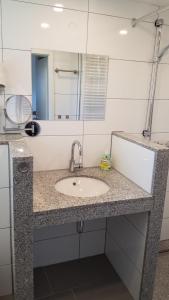 a bathroom counter with a sink and a mirror at Alte Brennerei in Bissingen an der Teck