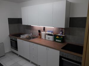a kitchen with white cabinets and a sink at Monteurunterkunft Wolkersdorf in Schwabach