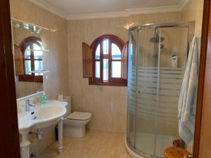 a bathroom with a shower and a sink and a toilet at VERDEPLAYA in Matalascañas +14 photos