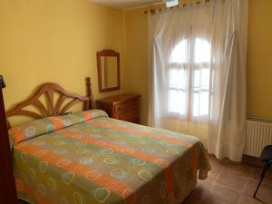 a bedroom with a bed and a large window at VERDEPLAYA in Matalascañas