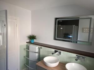 a bathroom with two sinks and a mirror at North Ings in Robin Hood's Bay