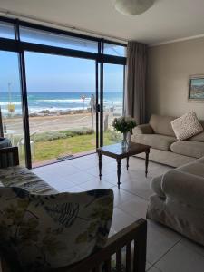 a living room with a view of the beach at Herolds Bay Accommodation - Smalstaan Downstairs in Herolds Bay