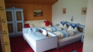 a bedroom with a bed with blue and white pillows at Neumaierhof in Haus im Ennstal