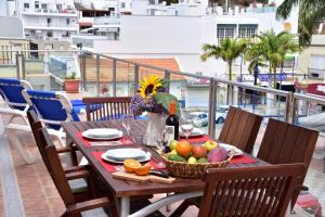 a table with a basket of fruit on a balcony at BEACH SIDE in Puerto de Mogán