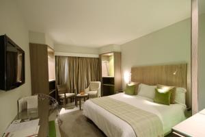 
a hotel room with two beds and a television at Golf Royal Hotel in Tunis

