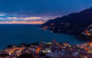 a view of a city and the ocean at night at Santafe' in Vietri sul Mare